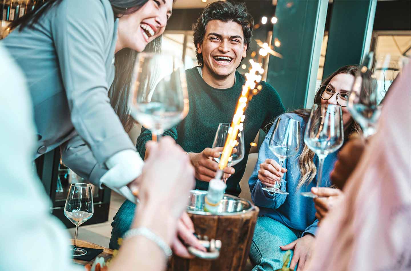 Junge Leute feiern Party in schicker Cocktailbar und trinken Champagner