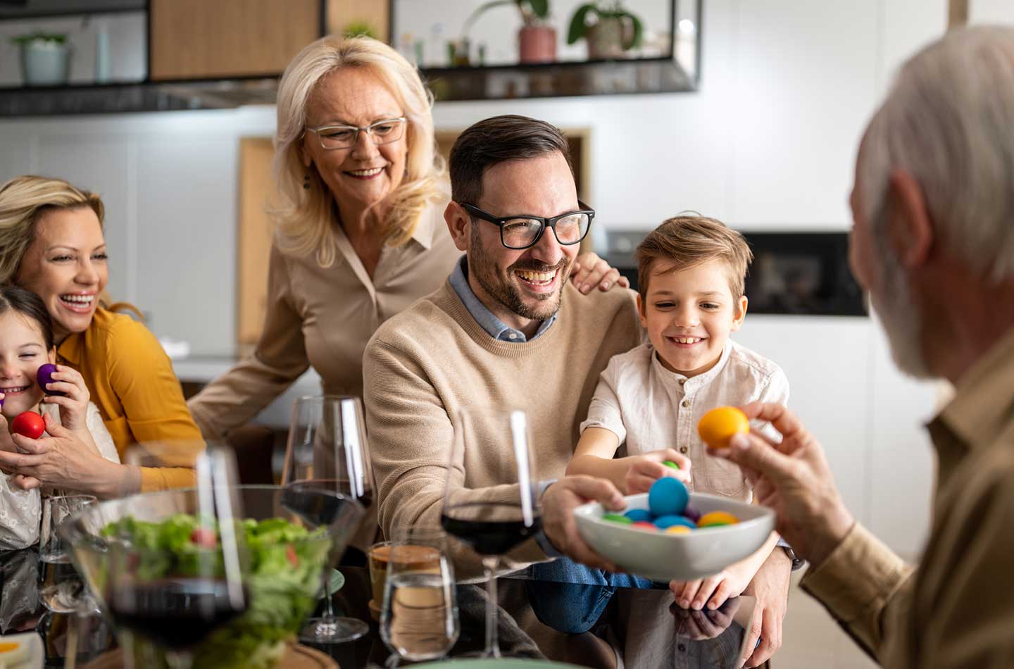 Familie sitzt gut gelaunt an Ostern zusammen.